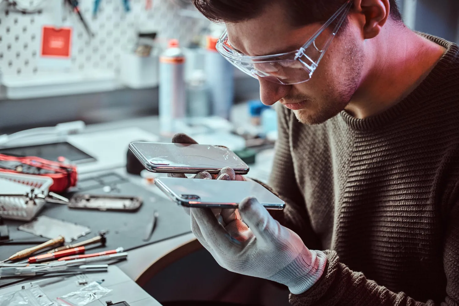 Close-up of hands repairing electronic device